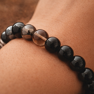 Black tourmaline smoky quartz hematite bracelet worn by a hand