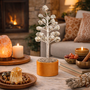 Decorative pyrite tree on a coffee table with candles and a fireplace in the background